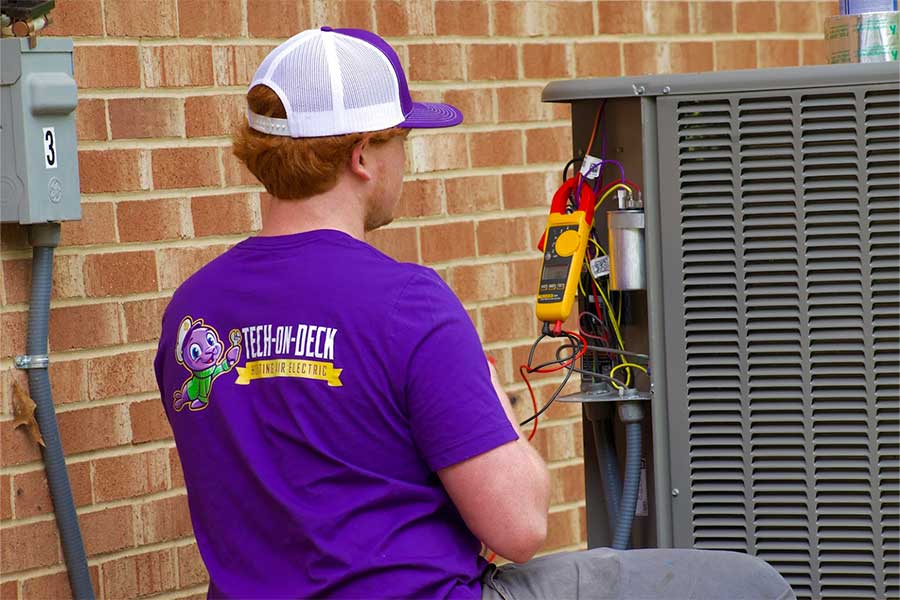 Emergency AC repair in Raleigh NC with technician testing unit